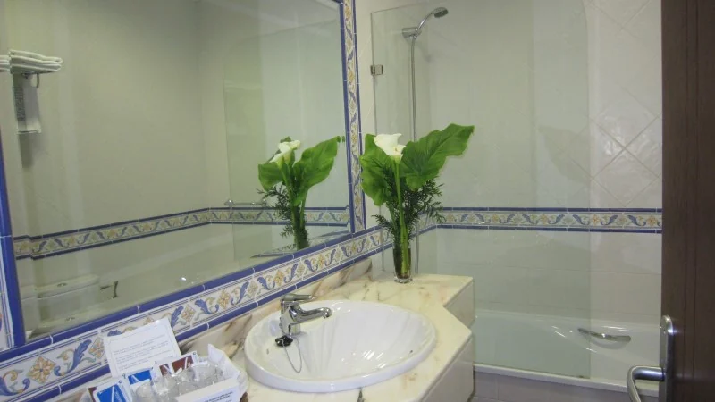 Washbasin, mirror and bath in a room bathroom