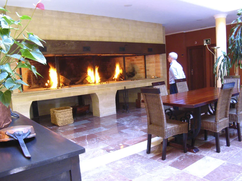 Lit fireplace beside a table in the lounge