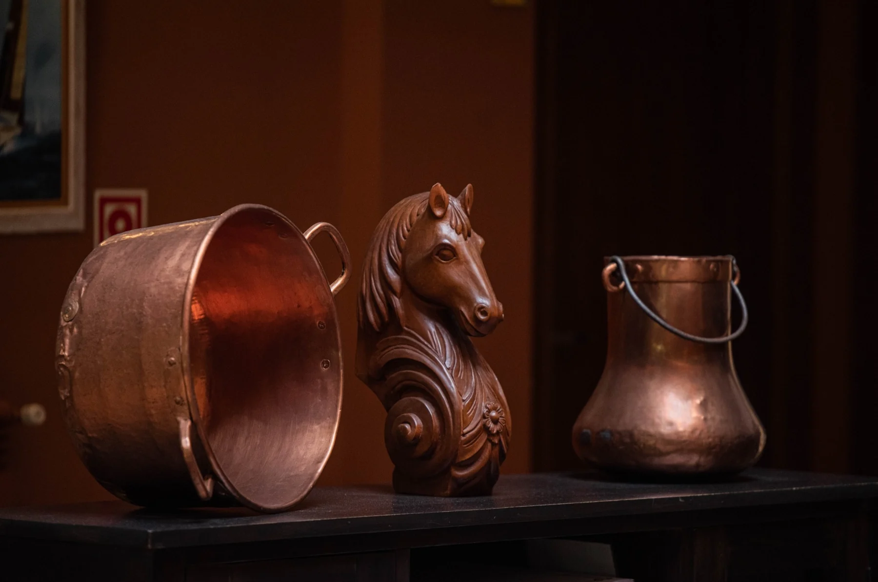 Decorative copper pieces beside the fireplace