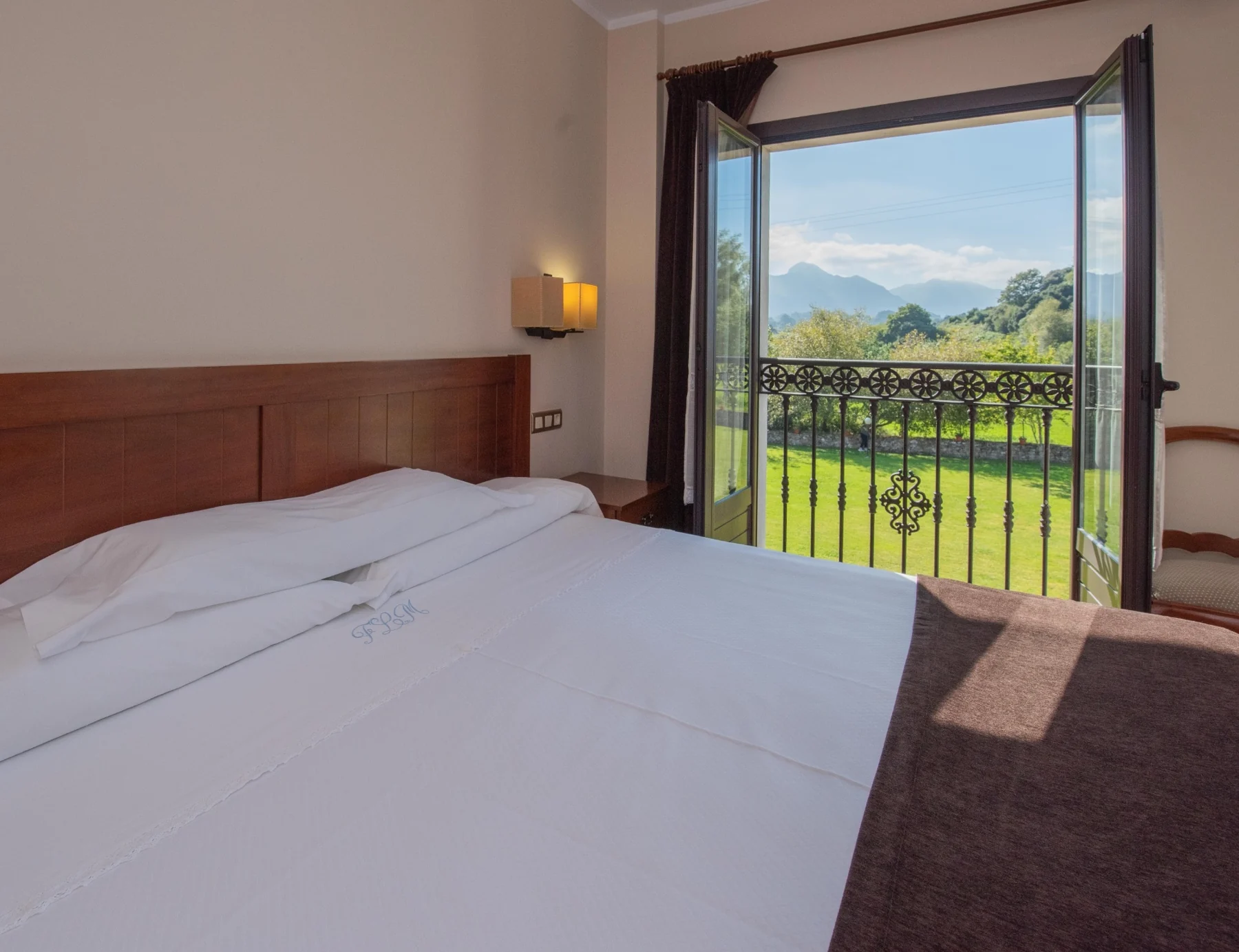 Double bed beside the balcony with mountain views