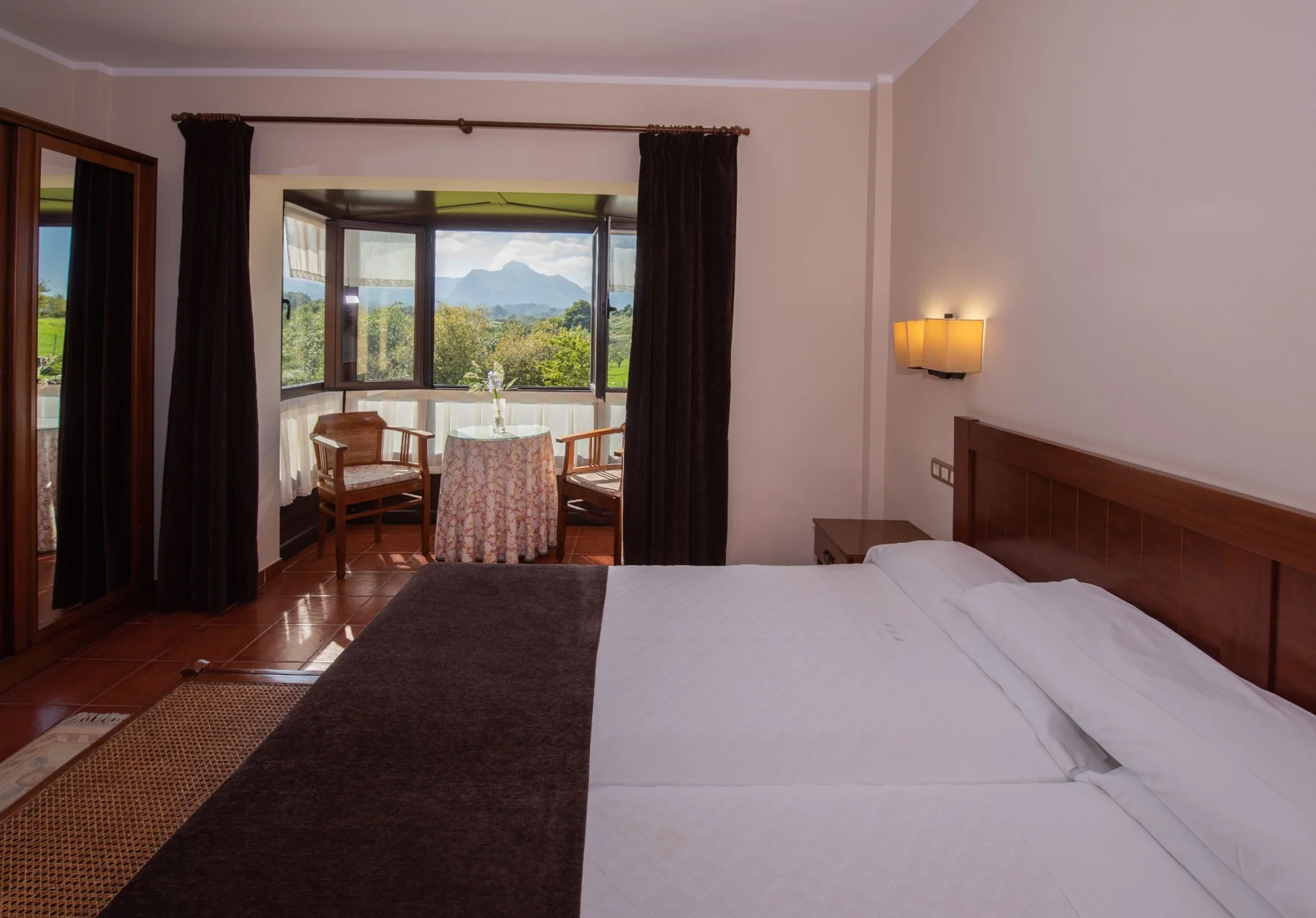 Double bed and sitting area beside the windows