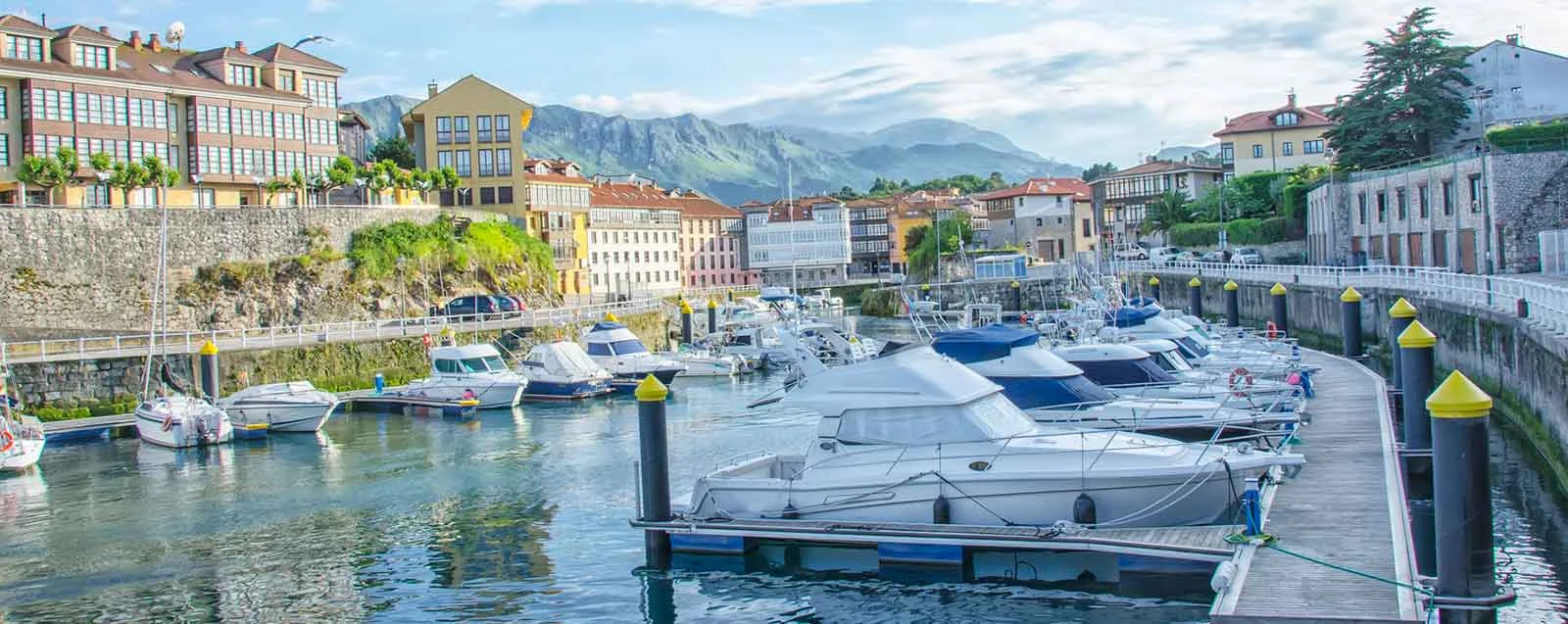 Boats and waterfront houses in Llanes harbour
