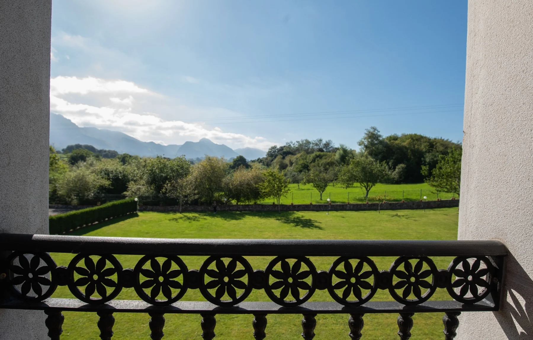 Garden and mountain views from a balcony